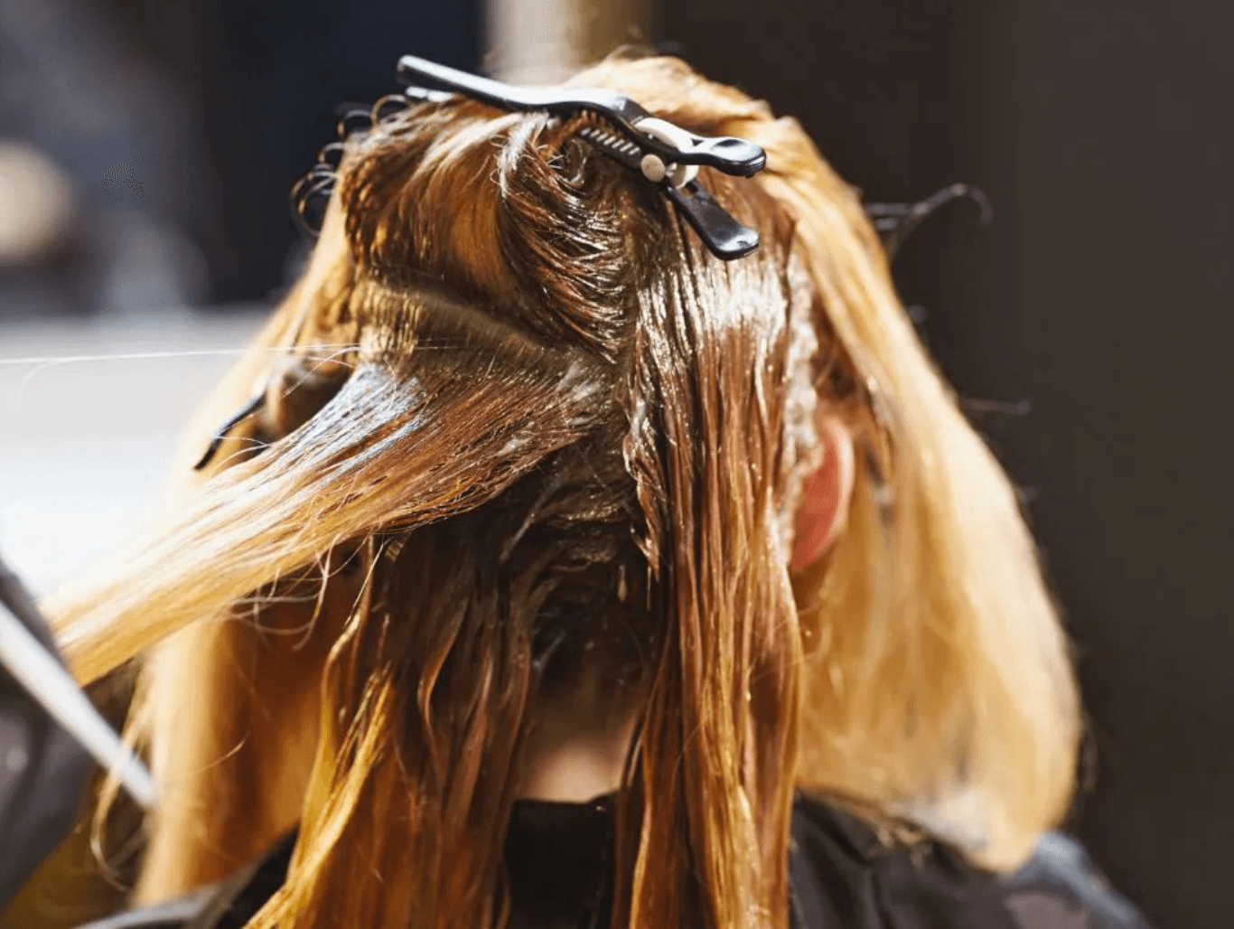 Close-up of full head colour being applied to a client’s hair in sections using Aveda professional colour — representing expert colour services at The Pamper Suite in Bexley.