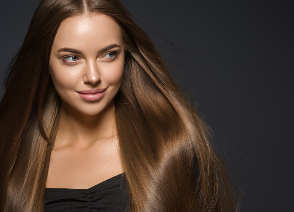 Woman with long, smooth, shiny hair after Aveda conditioning treatment at The Pamper Suite in Bexley