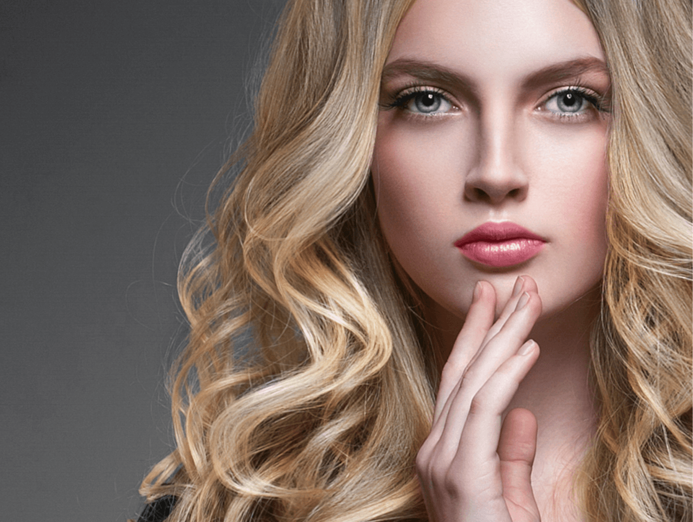 Woman with soft, voluminous blonde hair featuring full head woven highlights — representing expert Aveda highlighting at The Pamper Suite in Bexley.