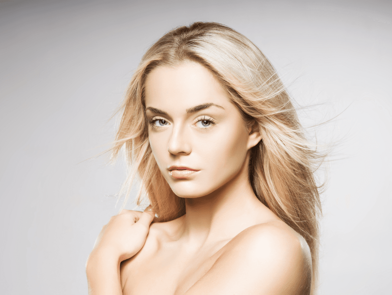 Woman with flowing, bright blonde highlights styled in soft waves — representing half head woven foils created with Aveda colour at The Pamper Suite in Bexley.