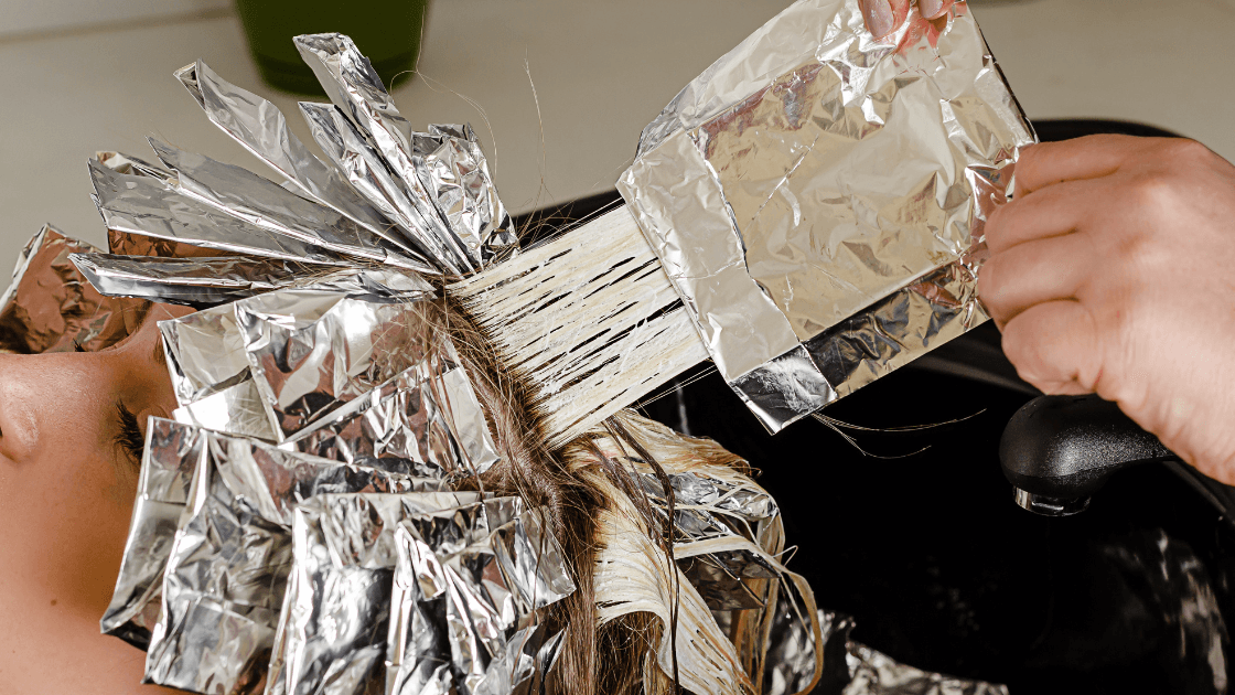 Close-up of professional hair highlighting using foils and lightener – showcasing expert highlighting techniques at The Pamper Suite in Bexley.