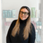 Sara White, experienced hair stylist at The Pamper Suite in Bexley, standing in front of Aveda product shelves.