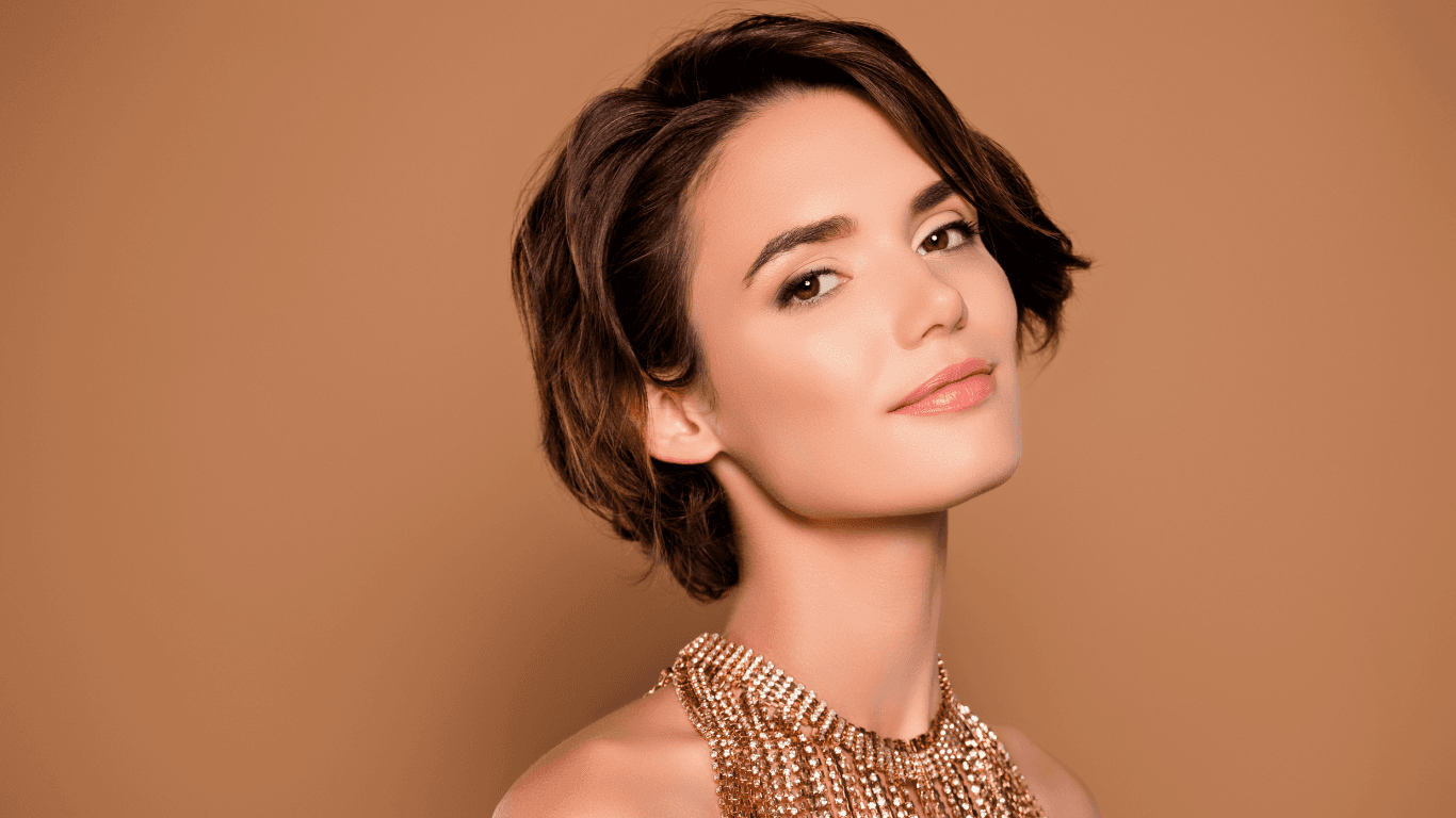 Confident woman with a soft short hairstyle and glowing colour finish, representing expert hair colouring and styling at The Pamper Suite in Bexley.