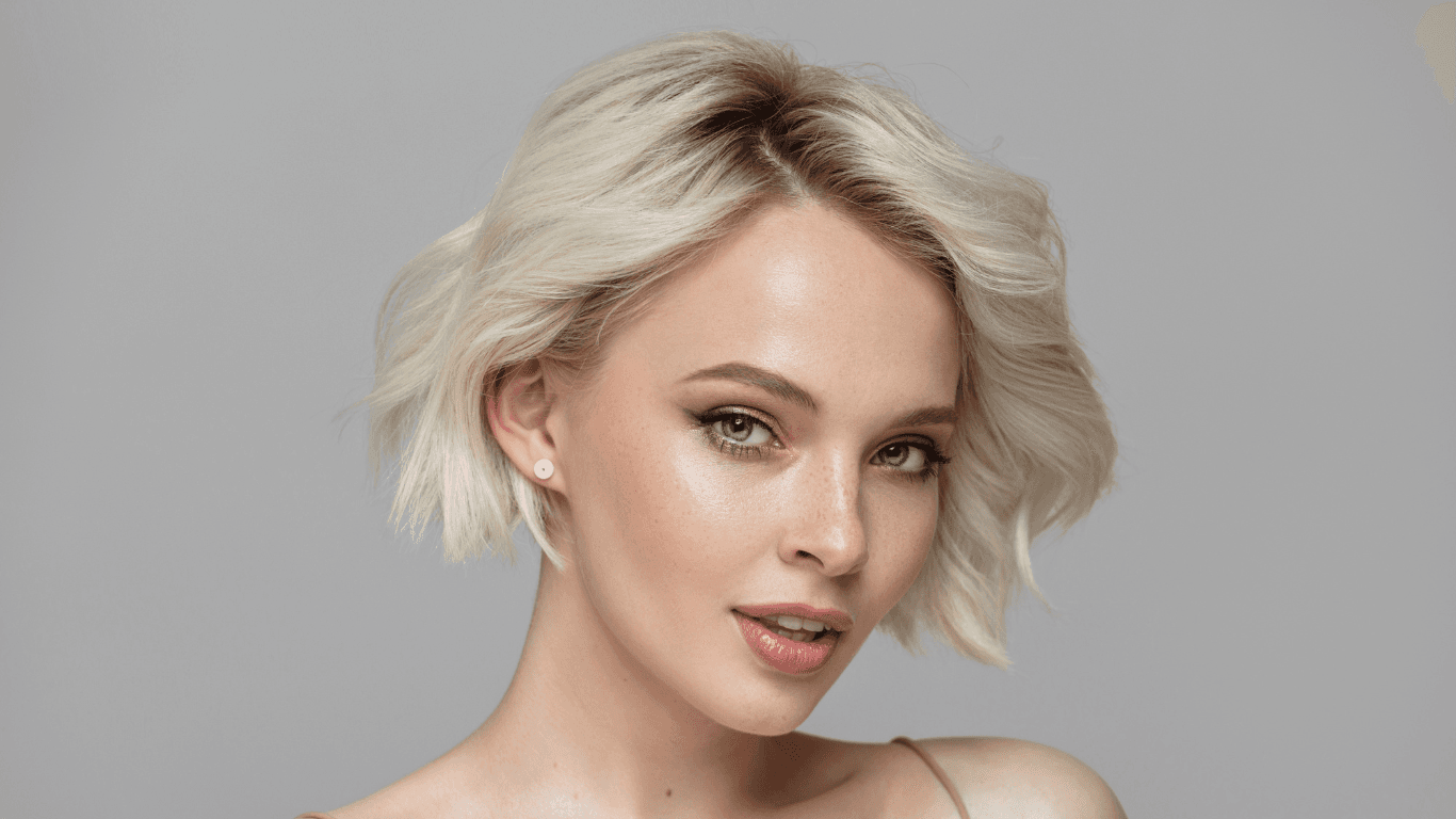 Woman with sleek, icy blonde T-section highlights styled into a soft textured bob — representing low-maintenance colour upkeep at The Pamper Suite in Bexley.