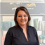 Tracy Essam, expert hairdresser and owner of The Pamper Suite salon in Bexley, standing in front of Aveda product display.